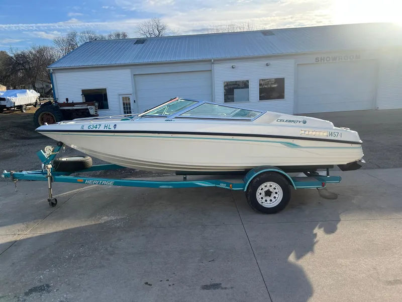 Slide: The Image of 1992 Celebrity 180 Bowrider boat on trailer, parked outside a building. - 4
