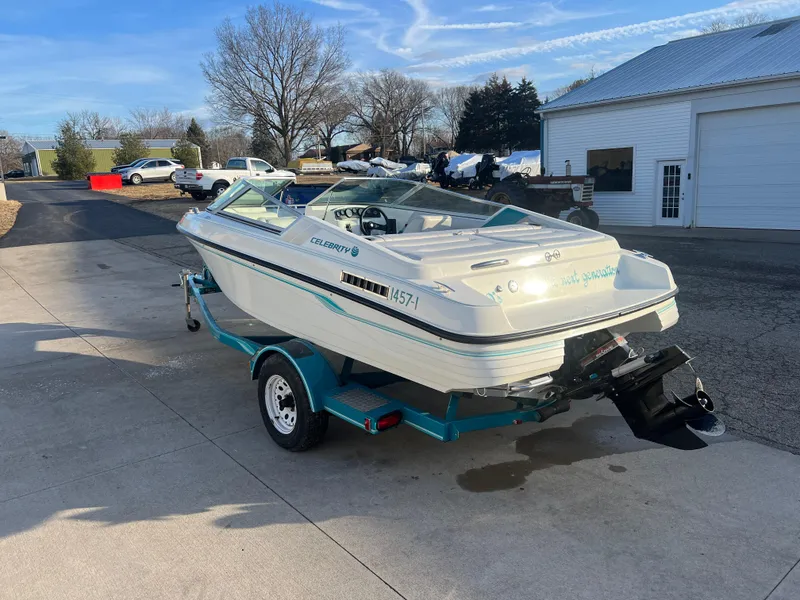 Slide: The Image of 1992 Celebrity 180 Bowrider boat on trailer, parked in driveway, sunny day. - 5