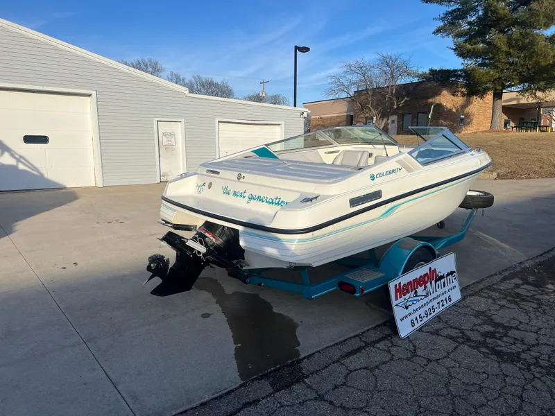 Slide: The Image of 1992 Celebrity 180 Bowrider boat on trailer, parked outside a garage. - 7