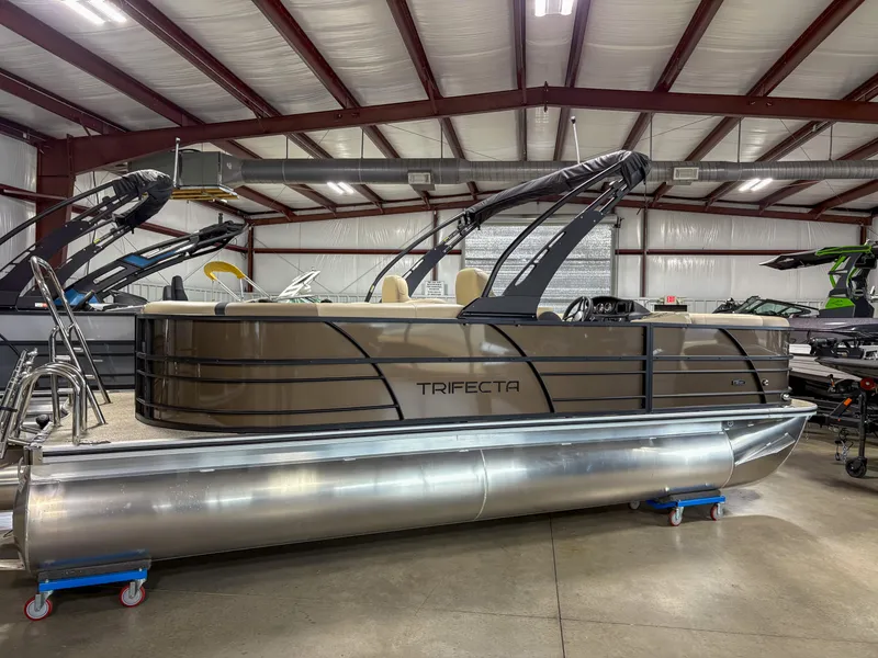 The Image of 2025 Trifecta 22 RF CS Arch pontoon boat in a showroom setting. - 1