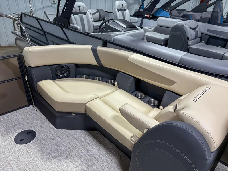 Slide: The Image of Luxurious seating on 2025 Trifecta 22 RF CS Arch pontoon boat, featuring beige and gray upholstery. - 11