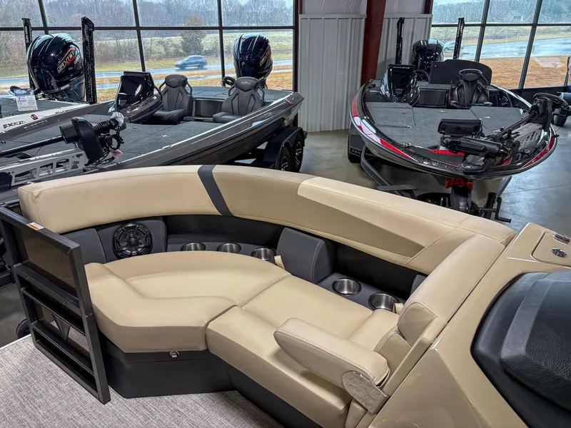 Slide: The Image of 2025 Trifecta 22 RF CS Arch boat interior with beige seating in showroom. - 4