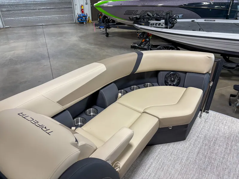 Slide: The Image of Luxurious seating on 2025 Trifecta 22 RF CS Arch pontoon boat, featuring beige upholstery and cup holders. - 5