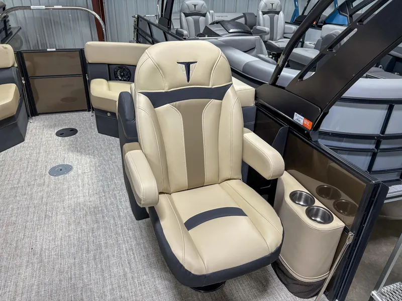 Slide: The Image of Luxurious seating on 2025 Trifecta 22 RF CS Arch pontoon boat, featuring beige upholstery and cup holders. - 6