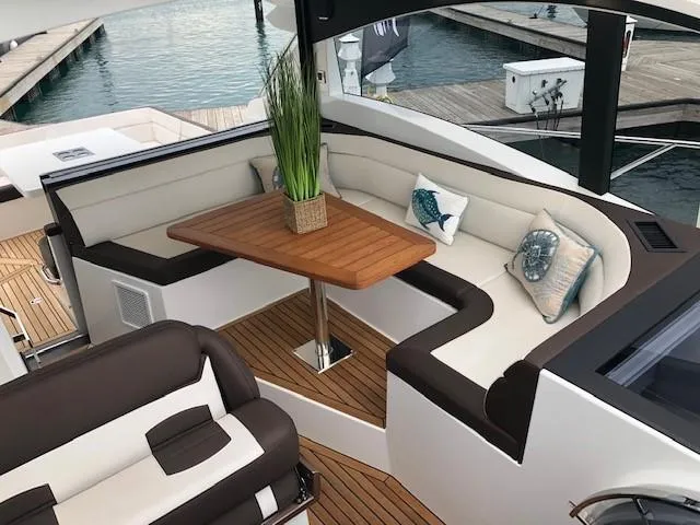 Slide: The Image of Luxurious seating area on 2018 Galeon 485 yacht with elegant cushions and wooden table. - 15