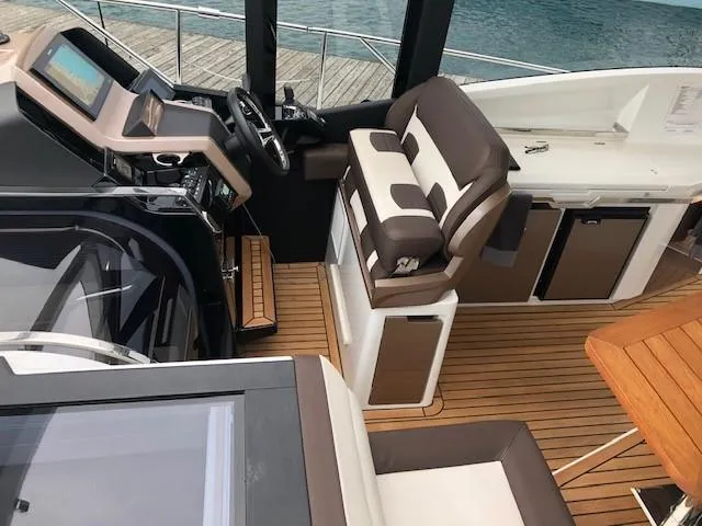 Slide: The Image of Interior of 2018 Galeon 485 yacht with modern helm and seating. - 18