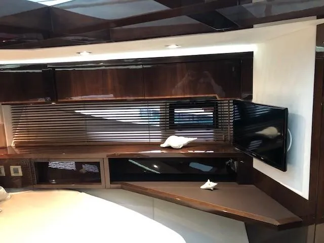 Slide: The Image of Luxurious interior of 2018 Galeon 485 yacht with sleek wood finishes and modern TV setup. - 30