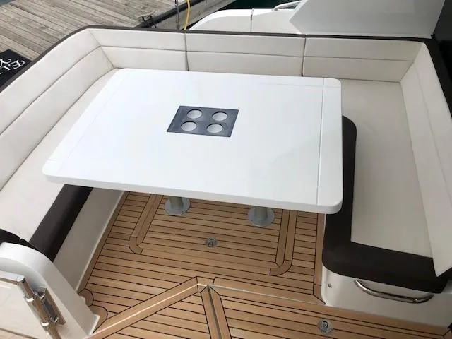 Slide: The Image of Luxurious seating area on 2018 Galeon 485 yacht with sleek table and cushioned benches. - 7