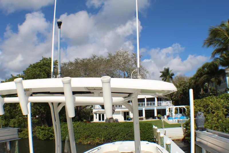 Slide: The Image of 2017 Boston Whaler 270 Dauntless boat docked near waterfront property, under clear blue sky. - 14