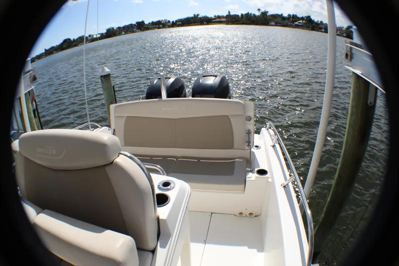 Slide: The Image of 2017 Boston Whaler 270 Dauntless boat interior with dual engines on a sunny day. - 15