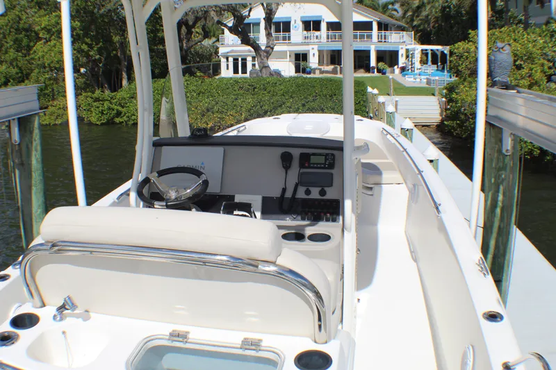 Slide: The Image of 2017 Boston Whaler 270 Dauntless boat docked near waterfront home. - 17