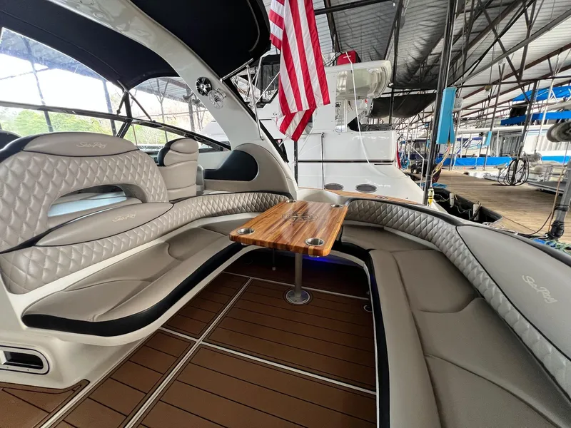 Slide: The Image of Luxurious 2002 Sea Ray 380 Sundancer yacht interior with elegant seating and wooden table. - 12