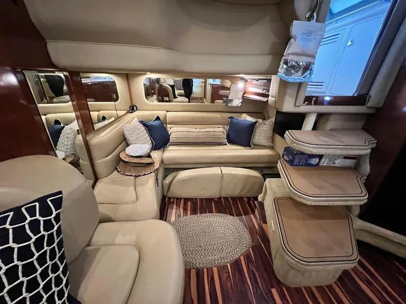 Slide: The Image of Luxurious interior of 2002 Sea Ray 380 Sundancer yacht with beige seating and wooden accents. - 16