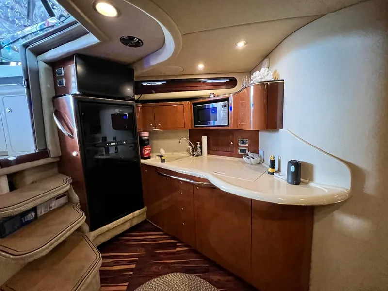 Slide: The Image of Interior of 2002 Sea Ray 380 Sundancer yacht with modern kitchen amenities. - 17
