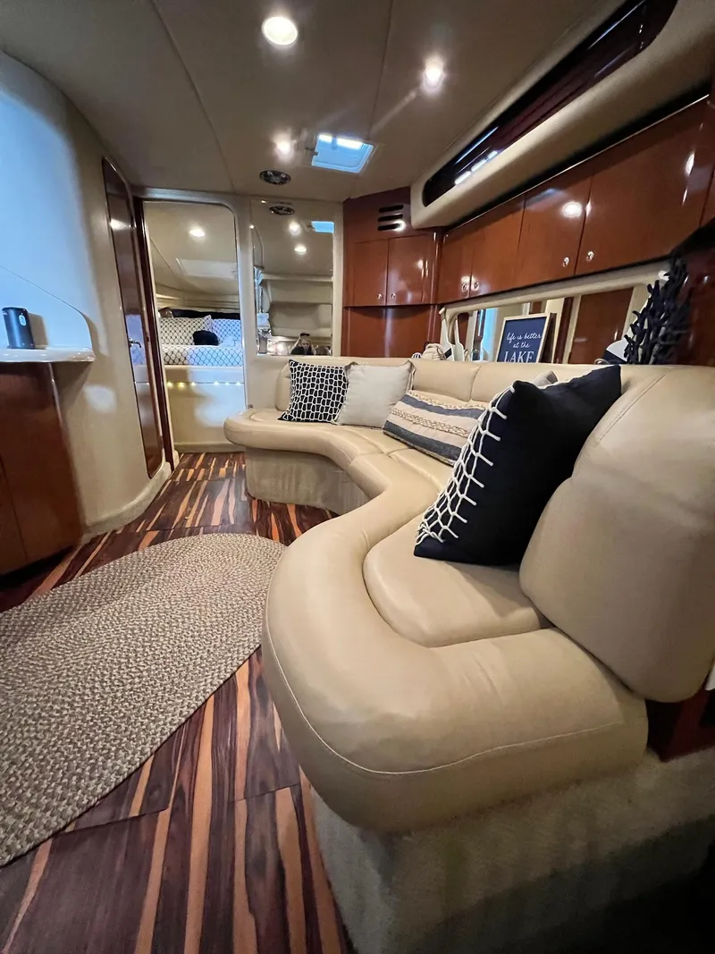 Slide: The Image of Luxurious interior of 2002 Sea Ray 380 Sundancer with plush seating and elegant wood finishes. - 18