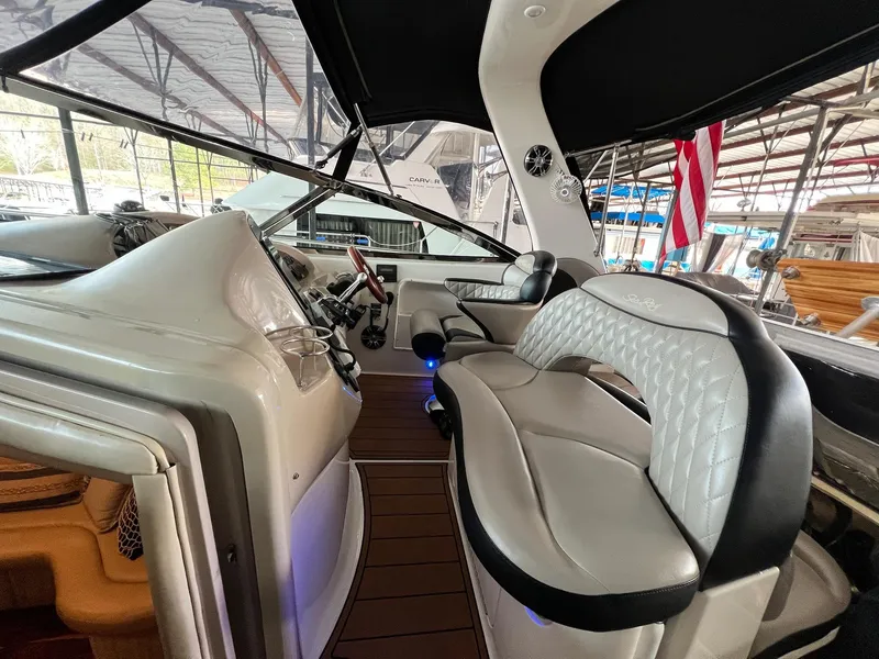 Slide: The Image of Interior of 2002 Sea Ray 380 Sundancer yacht with luxurious seating and modern dashboard. - 22