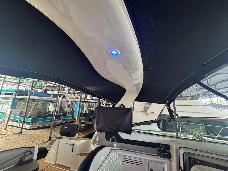 Slide: The Image of 2002 Sea Ray 380 Sundancer interior with black canopy and blue LED lights. - 30