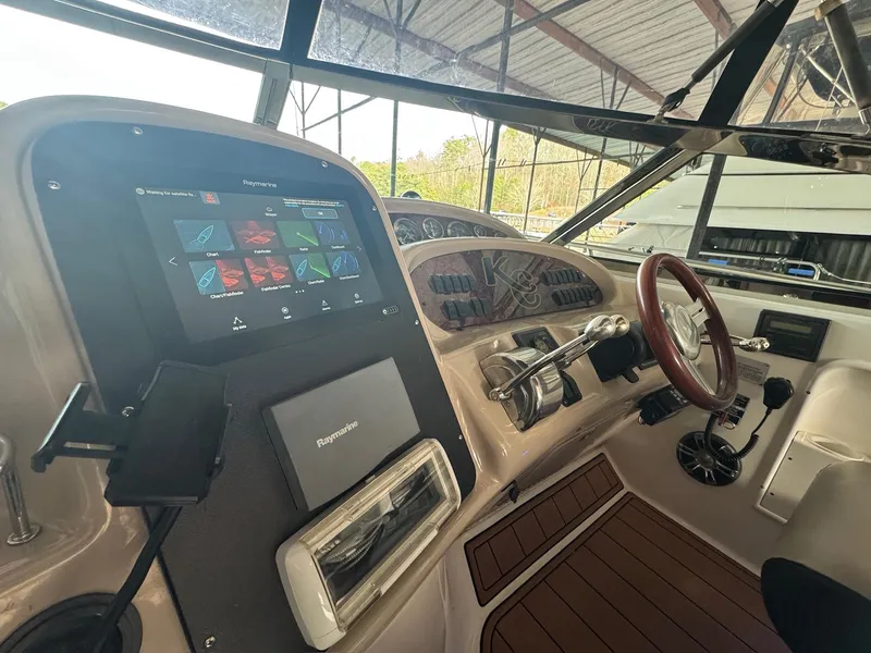 Slide: The Image of Helm of 2002 Sea Ray 380 Sundancer with modern navigation equipment and wooden steering wheel. - 35