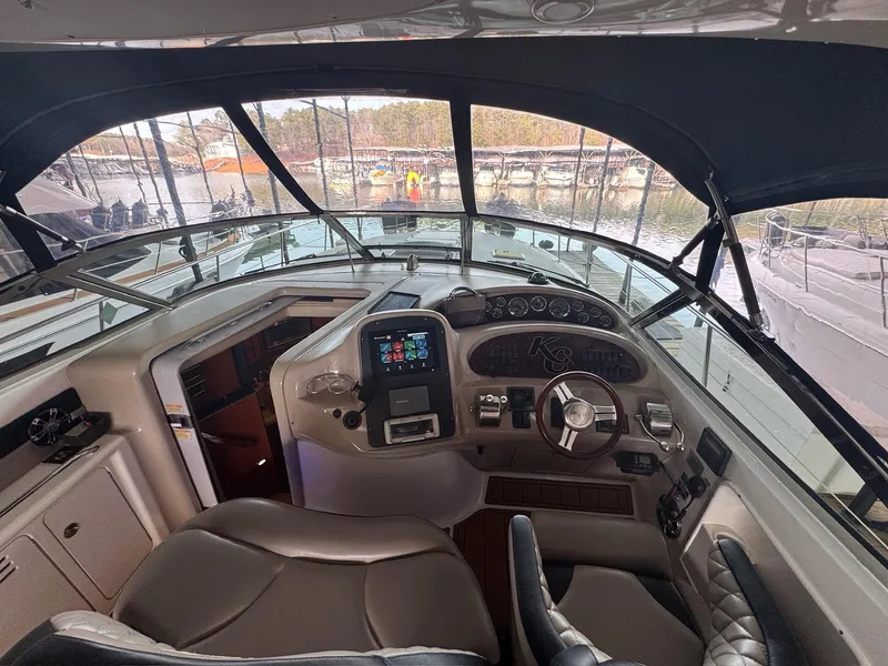 Slide: The Image of Cockpit of 2002 Sea Ray 380 Sundancer yacht with steering wheel and navigation controls. - 36
