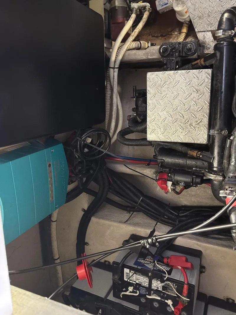 Slide: The Image of Engine compartment of a 2002 Sea Ray 380 Sundancer with visible wiring and components. - 41