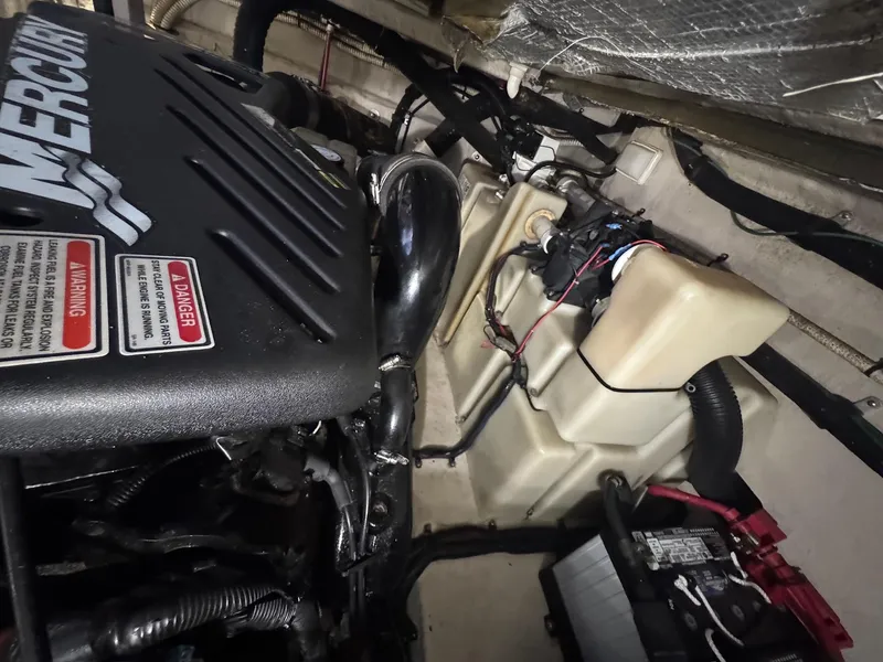 Slide: The Image of Engine compartment of a 2002 Sea Ray 380 Sundancer boat, featuring a Mercury engine. - 43