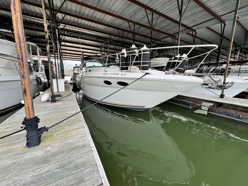 Slide: The Image of 2002 Sea Ray 380 Sundancer docked in a covered marina. - 5