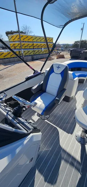 Slide: The Image of 2022 Berkshire 25E STS boat interior with modern seating and steering wheel. - 11