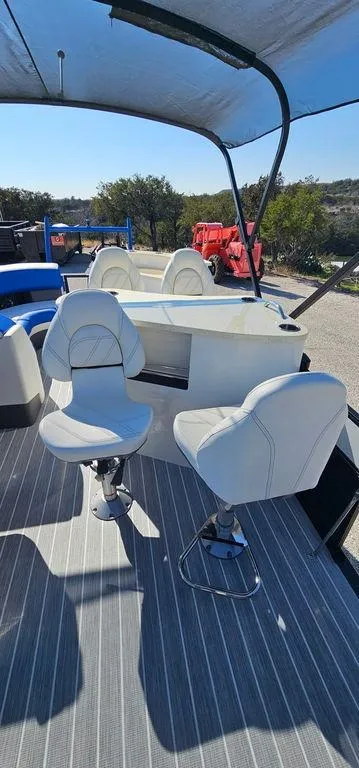 Slide: The Image of 2022 Berkshire 25E STS pontoon boat with white seating and canopy. - 12
