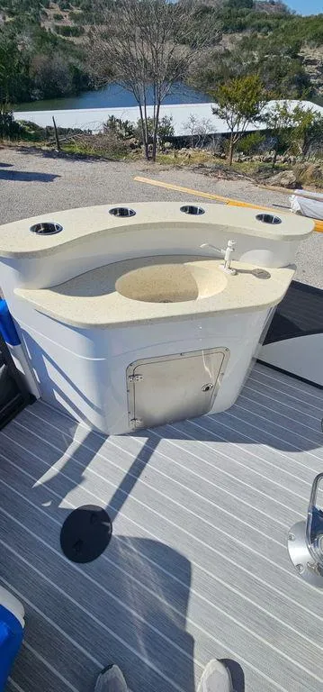 Slide: The Image of 2022 Berkshire 25E STS boat with a built-in bar and cup holders on deck. - 15