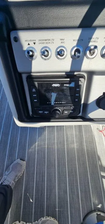 Slide: The Image of Control panel of a 2022 Berkshire 25E STS boat with switches and a display. - 19