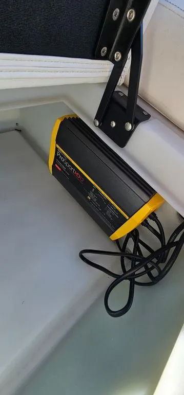 Slide: The Image of Battery charger installed in a 2022 Berkshire 25E STS boat compartment. - 25