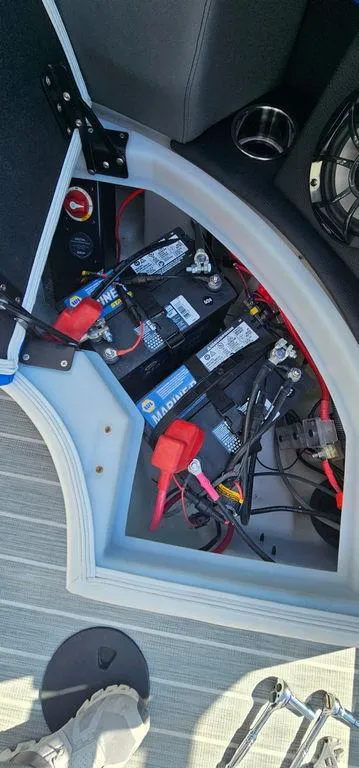 Slide: The Image of Battery compartment of a 2022 Berkshire 25E STS boat, showing wiring and connections. - 26