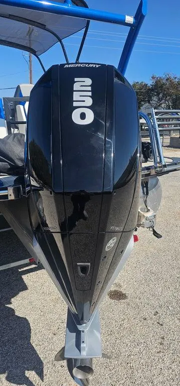 Slide: The Image of 2022 Berkshire 25E STS with Mercury 250 outboard engine, parked on a sunny day. - 4