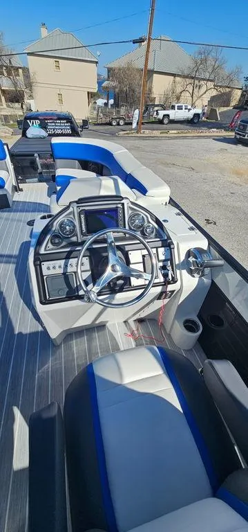 Slide: The Image of 2022 Berkshire 25E STS boat interior with modern steering console and seating. - 9