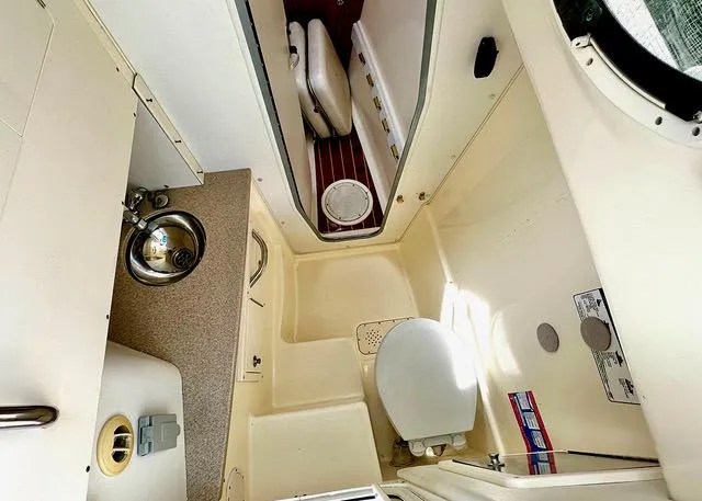 Slide: The Image of 2009 World Cat 290 EC boat interior with compact bathroom and sink. - 10