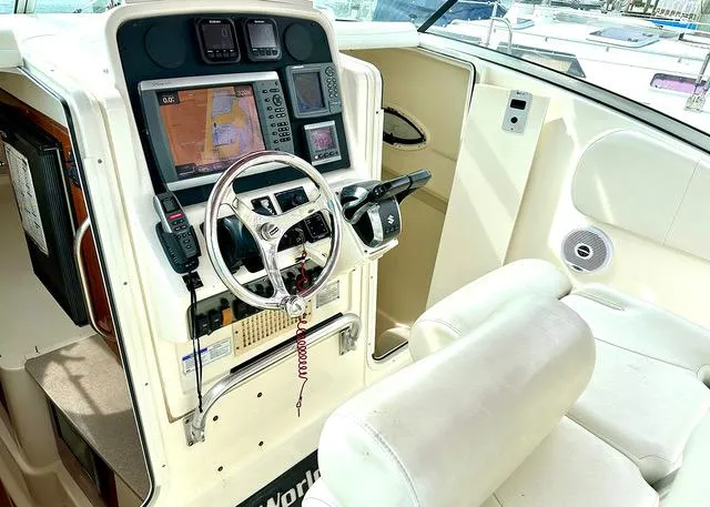 Slide: The Image of 2009 World Cat 290 EC boat cockpit with navigation equipment and steering wheel. - 11