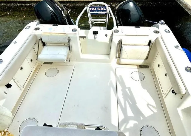 Slide: The Image of 2009 World Cat 290 EC boat deck with dual engines and seating. - 5