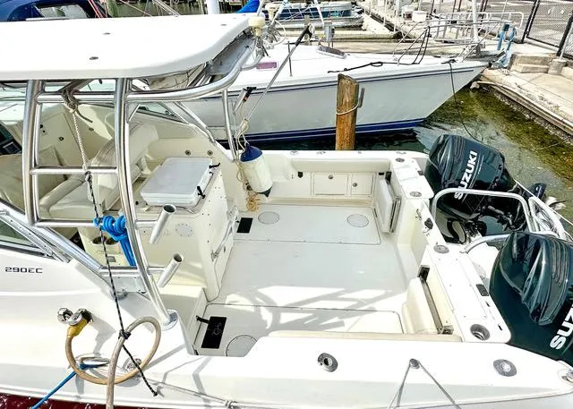 Slide: The Image of 2009 World Cat 290 EC boat with dual Suzuki engines docked at marina. - 6