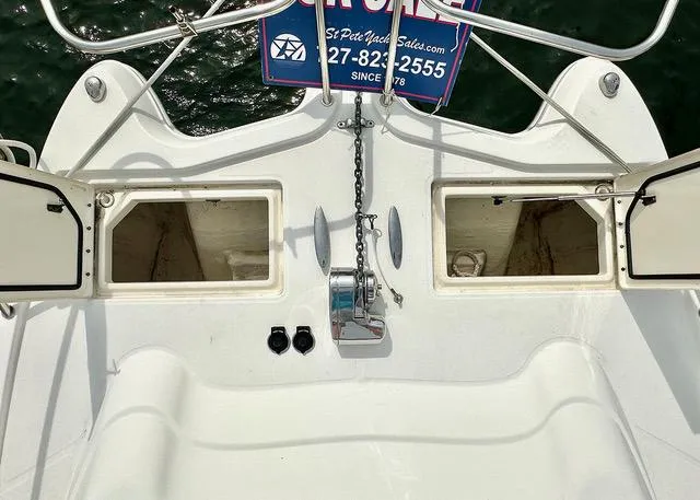 Slide: The Image of 2009 World Cat 290 EC boat deck with open storage compartments and anchor chain. - 8