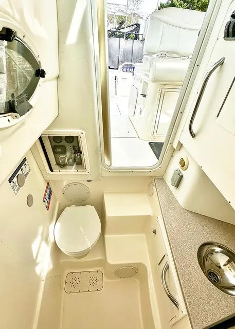 Slide: The Image of 2009 World Cat 290 EC boat interior with compact bathroom and sink. - 9