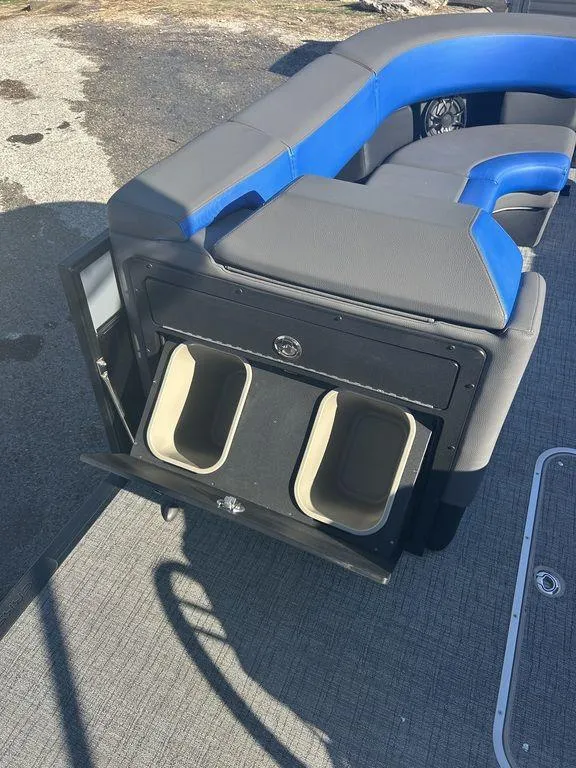 Slide: The Image of 2023 Berkshire 25UL STS 3.0 boat interior with blue and gray seating and storage compartments. - 14