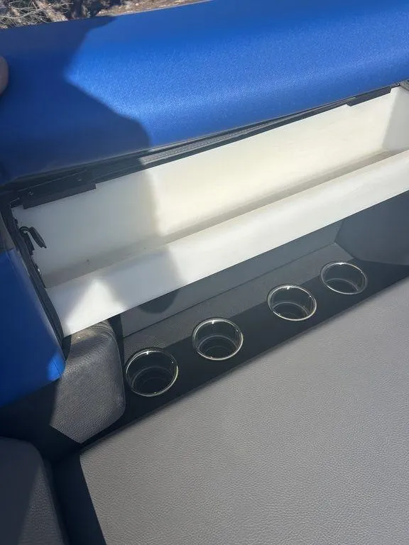 Slide: The Image of 2023 Berkshire 25UL STS 3.0 boat interior with cup holders and storage compartment. - 16