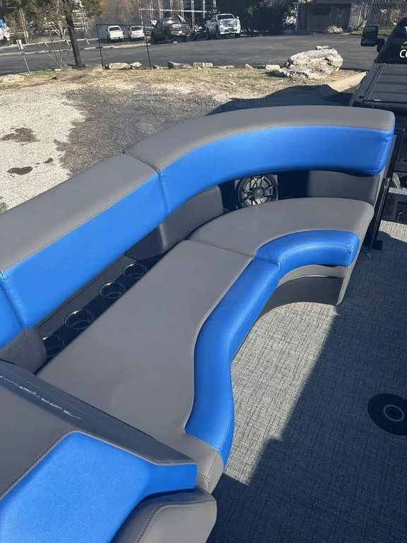 Slide: The Image of 2023 Berkshire 25UL STS 3.0 boat with blue and gray seating. - 17