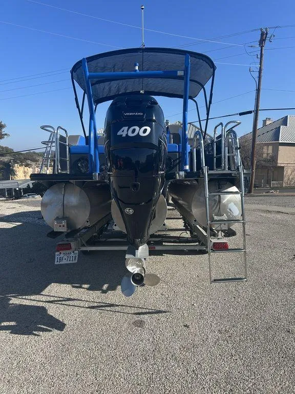 Slide: The Image of 2023 Berkshire 25UL STS 3.0 pontoon boat with powerful 400 horsepower engine, parked outdoors. - 4