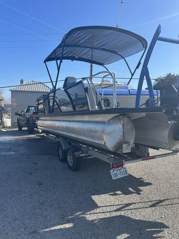 Slide: The Image of 2023 Berkshire 25UL STS 3.0 pontoon boat on trailer, parked outdoors. - 5