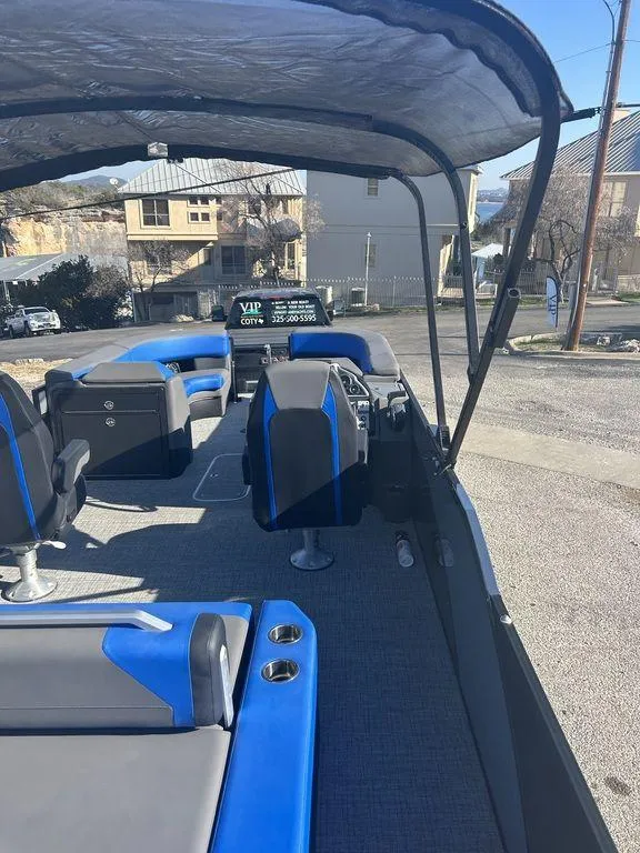 Slide: The Image of 2023 Berkshire 25UL STS 3.0 pontoon boat with blue and gray seating, docked outdoors. - 7