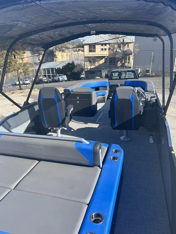 Slide: The Image of 2023 Berkshire 25UL STS 3.0 pontoon boat with blue and gray seating, under a canopy. - 8