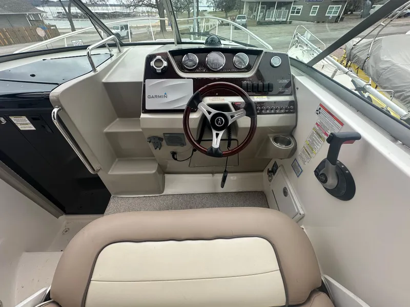 Slide: The Image of 2012 Sea Ray 280 Sundancer helm with Garmin navigation and modern controls. - 10