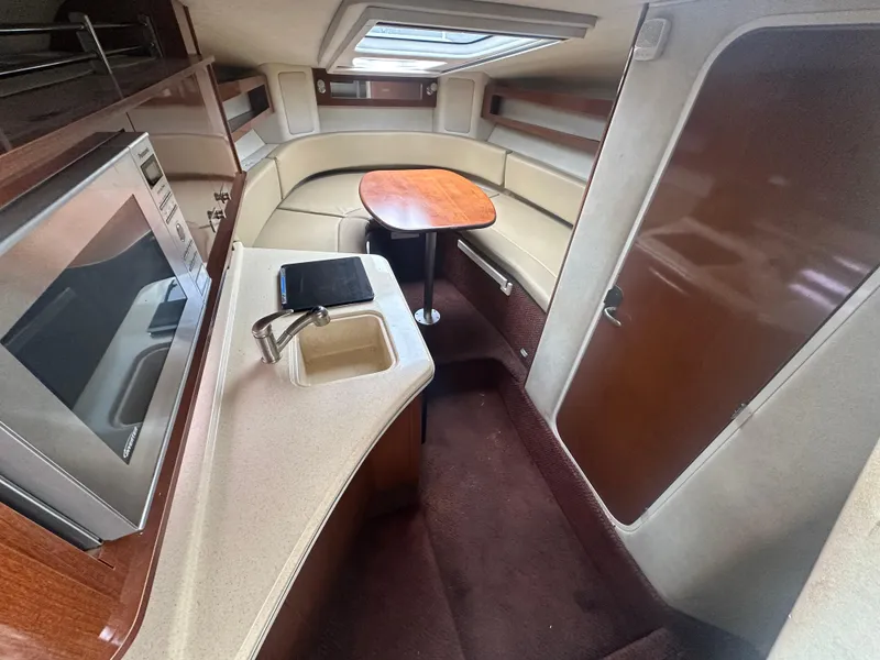 Slide: The Image of Interior of 2012 Sea Ray 280 Sundancer with kitchenette and seating area. - 13