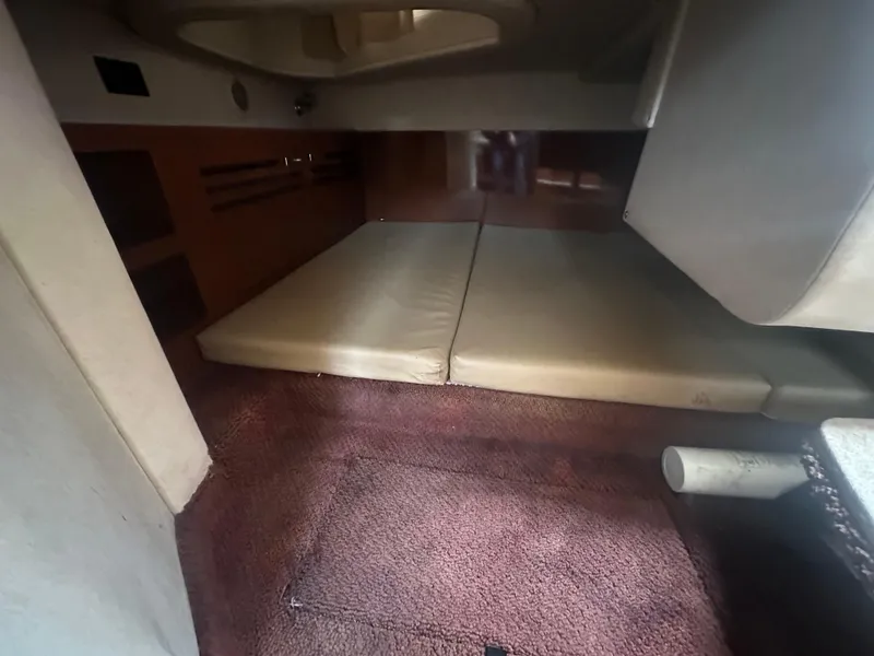 Slide: The Image of Interior cabin of 2012 Sea Ray 280 Sundancer with cushioned seating and carpeted floor. - 18